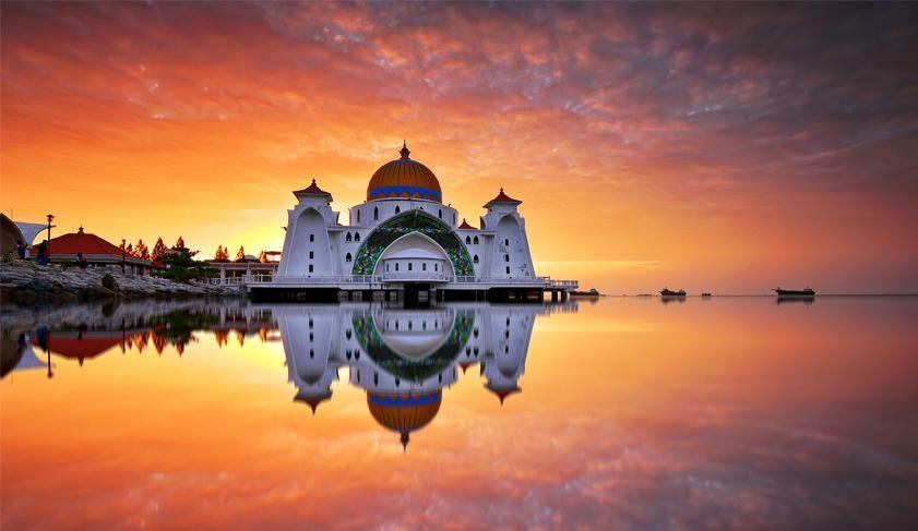 Clear reflections during sunrise at Straits Mosque in Melaka, Malaysia