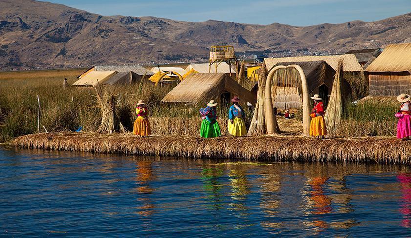 Locals welcoming you to the floating Uros Islands on Lake Titicaca, Peru