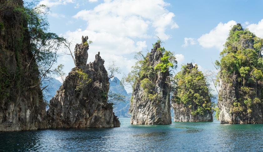 Huge limestone cliffs rising up on a open lake at Khao Sok National Park, Thailand. Huge limestone cliffs rising up on a open lake at Khao Sok National Park, Thailand.
