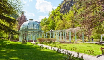 Borjomi Central Historical Park. Georgia. Source with healing mineral water. Beautiful pavilion with a glass dome