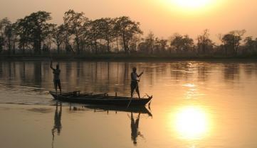 Locals punting along the river in Chitwan National Park, Nepal