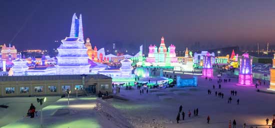 Advetures travellers in the cold climate in China for harbin ice festival which showcases some of the most amazing ice sculptures that usually involve buildings created out of ice