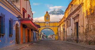 travel to Antigua and see the historic town located beneath the active volcano. One of the top destinations to visit in central america.