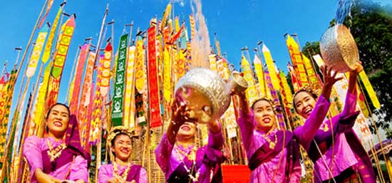 Locals in Thailand celebrate Songkran by throwing water. A great time to visit the country on a holiday trip.